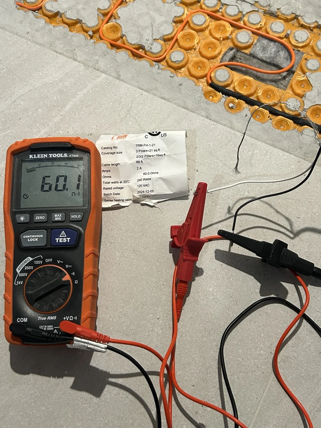 Meter reading 60.1 ohms beside a heating cable label specifying 60.0 ohms